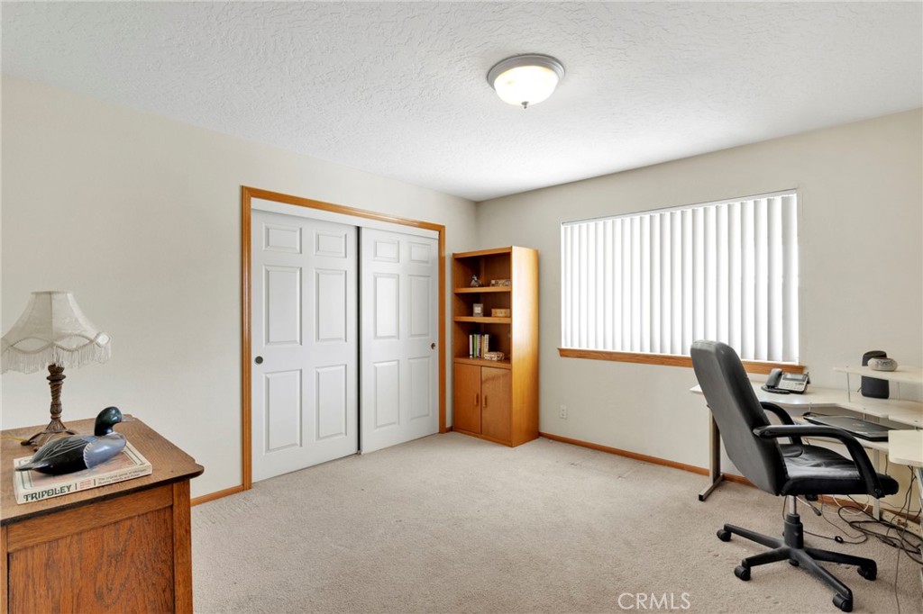 11062 Hollister Road Oak Hills, CA 92344 - Photo 35 of 69 a view of a workspace with furniture and a window