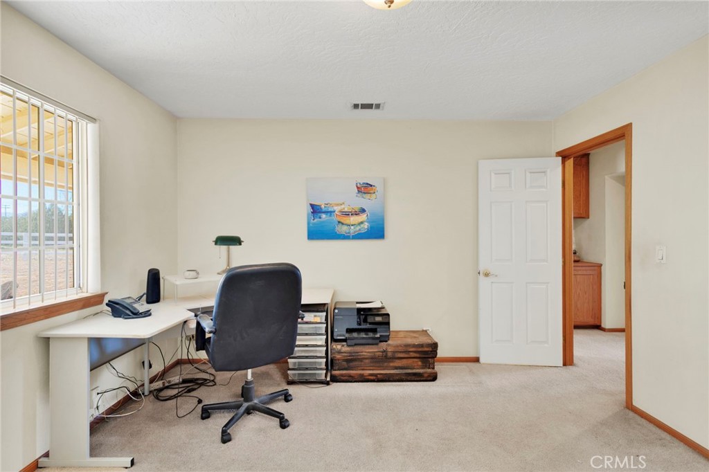 11062 Hollister Road Oak Hills, CA 92344 - Photo 36 of 69 a view of a workspace with furniture and a window