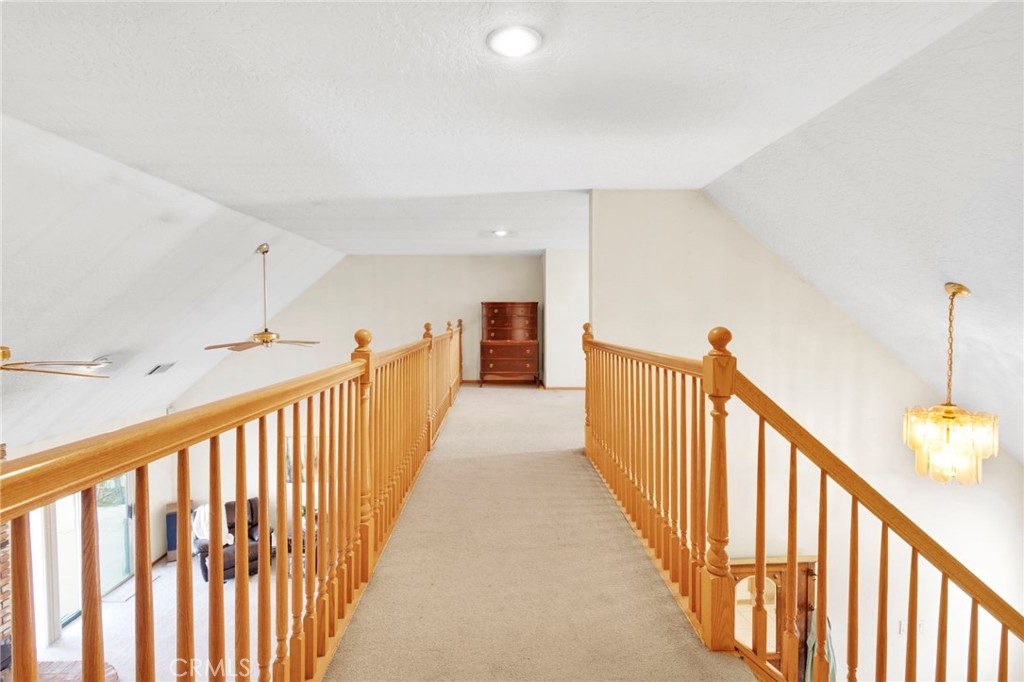 11062 Hollister Road Oak Hills, CA 92344 - Photo 37 of 69 a view of a hallway with wooden floor and stairs