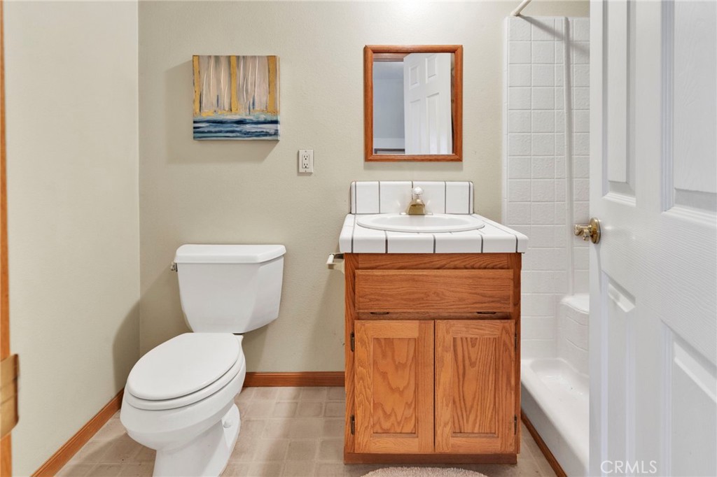 11062 Hollister Road Oak Hills, CA 92344 - Photo 47 of 69 a bathroom with a toilet sink and mirror
