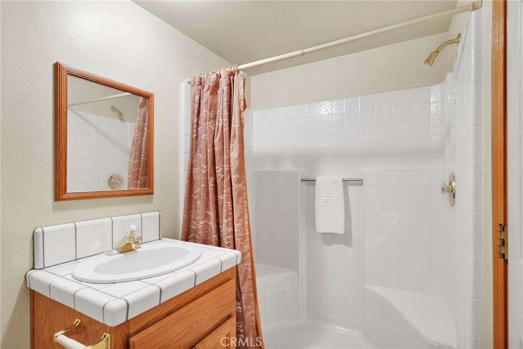 11062 Hollister Road Oak Hills, CA 92344 - Photo 48 of 69 a bathroom with a sink and a mirror