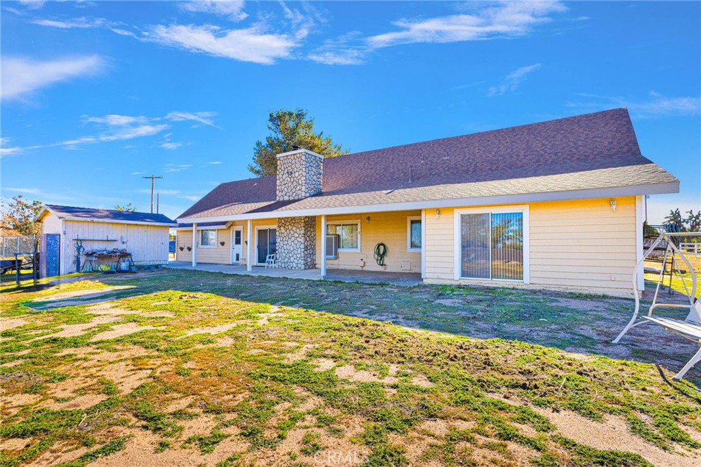 11062 Hollister Road Oak Hills, CA 92344 - Photo 51 of 69 a view of pool with lawn chairs and large tree