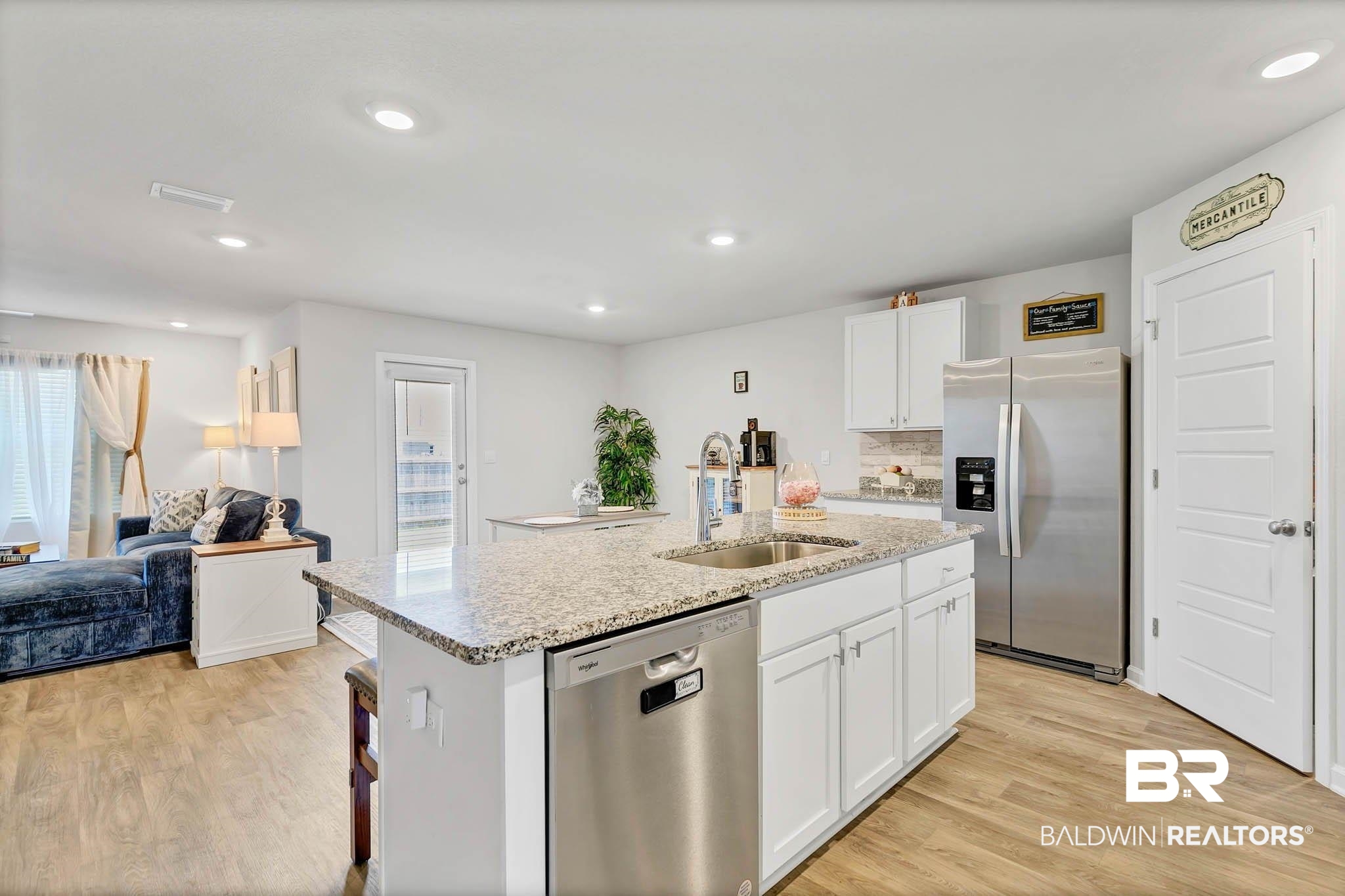 17217 REFLECTION Street Loxley, AL 36551 - Photo 81 of 83 Kitchen featuring appliances with stainless steel finishes, open floor plan, a center island with sink, white cabinetry, and recessed lighting