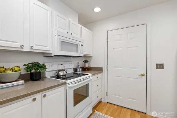 a kitchen with stainless steel appliances white cabinets and a stove