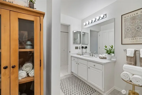 a spacious bathroom with a shower a sink and a mirror