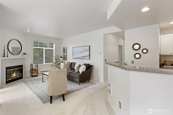 a living room with fireplace furniture and fireplace