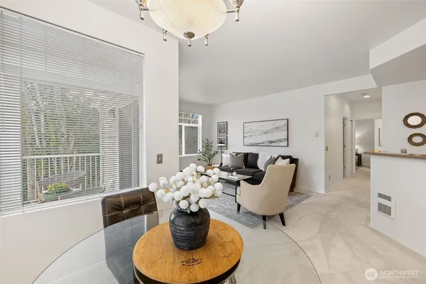 a living room with furniture potted plant and windows