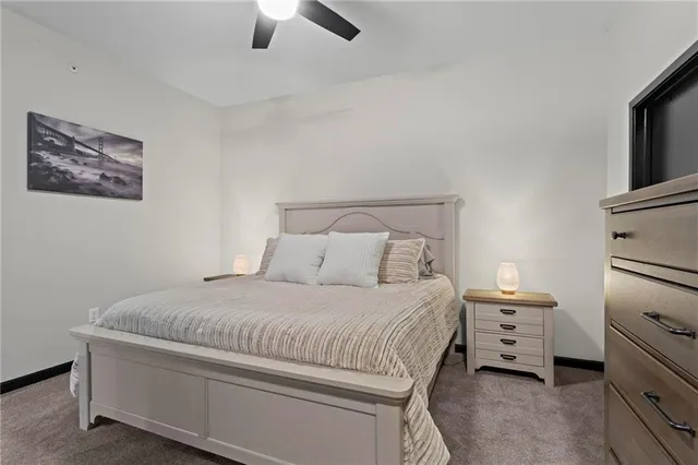 a bedroom with a bed and a tv on the dresser