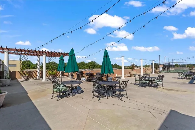 a view of a patio with dining table and chairs with a patio