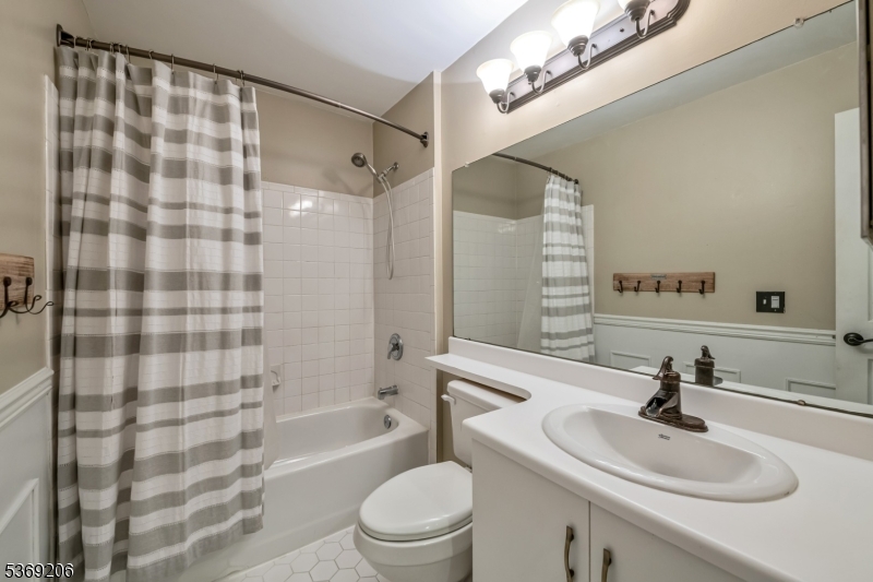 1096 Coventry Way Mahwah, NJ 07430 - Photo 15 of 28 a bathroom with a sink a toilet a mirror and shower