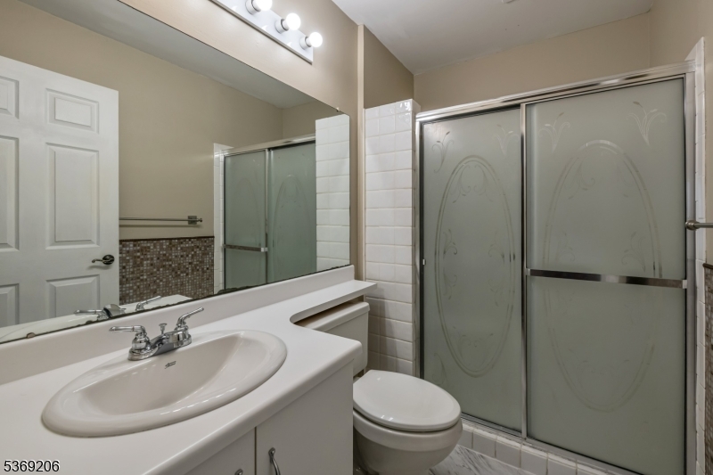 1096 Coventry Way Mahwah, NJ 07430 - Photo 17 of 28 a bathroom with a sink toilet and shower
