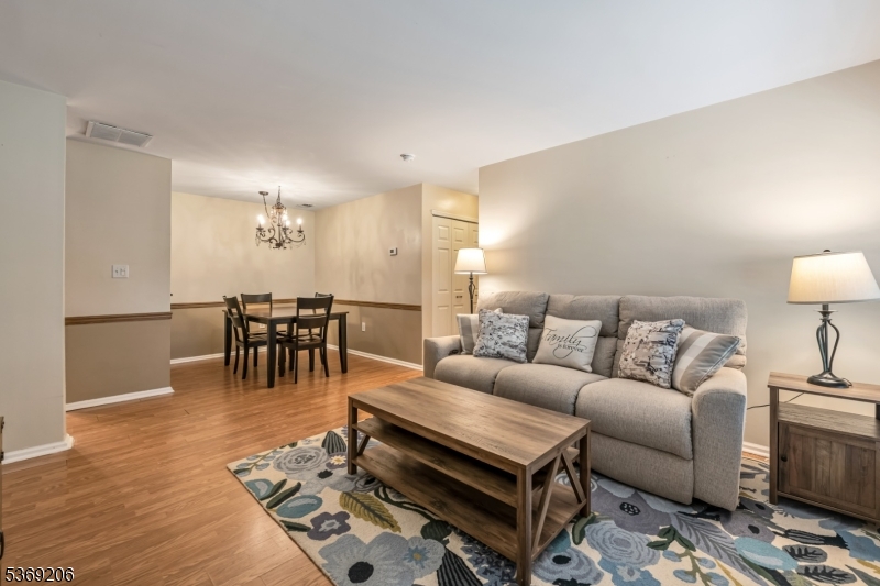 1096 Coventry Way Mahwah, NJ 07430 - Photo 4 of 28 a living room with furniture a dining table and a rug