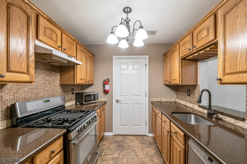 1096 Coventry Way Mahwah, NJ 07430 - Photo 6 of 28 a kitchen with a stove and a sink