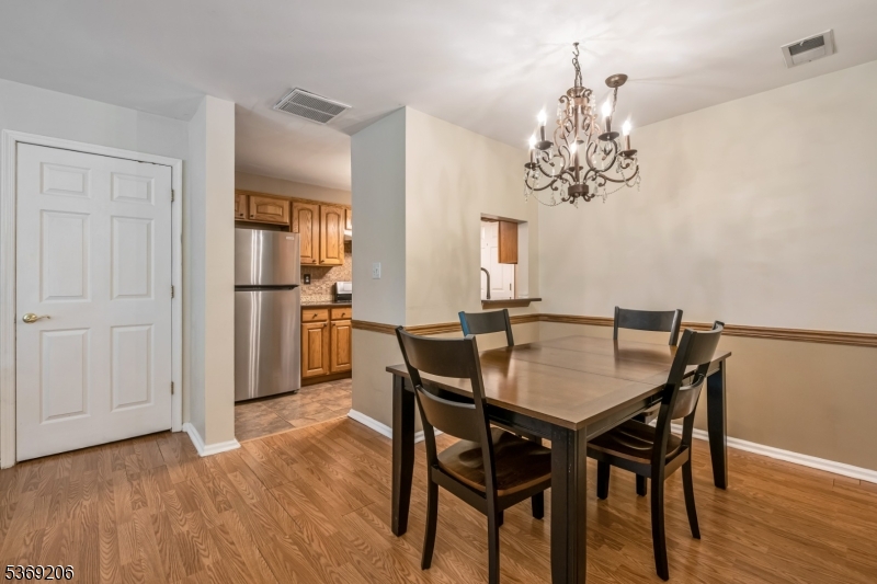 1096 Coventry Way Mahwah, NJ 07430 - Photo 10 of 28 a view of a dining room with furniture and wooden floor