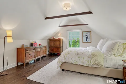 a living room with furniture and a dresser