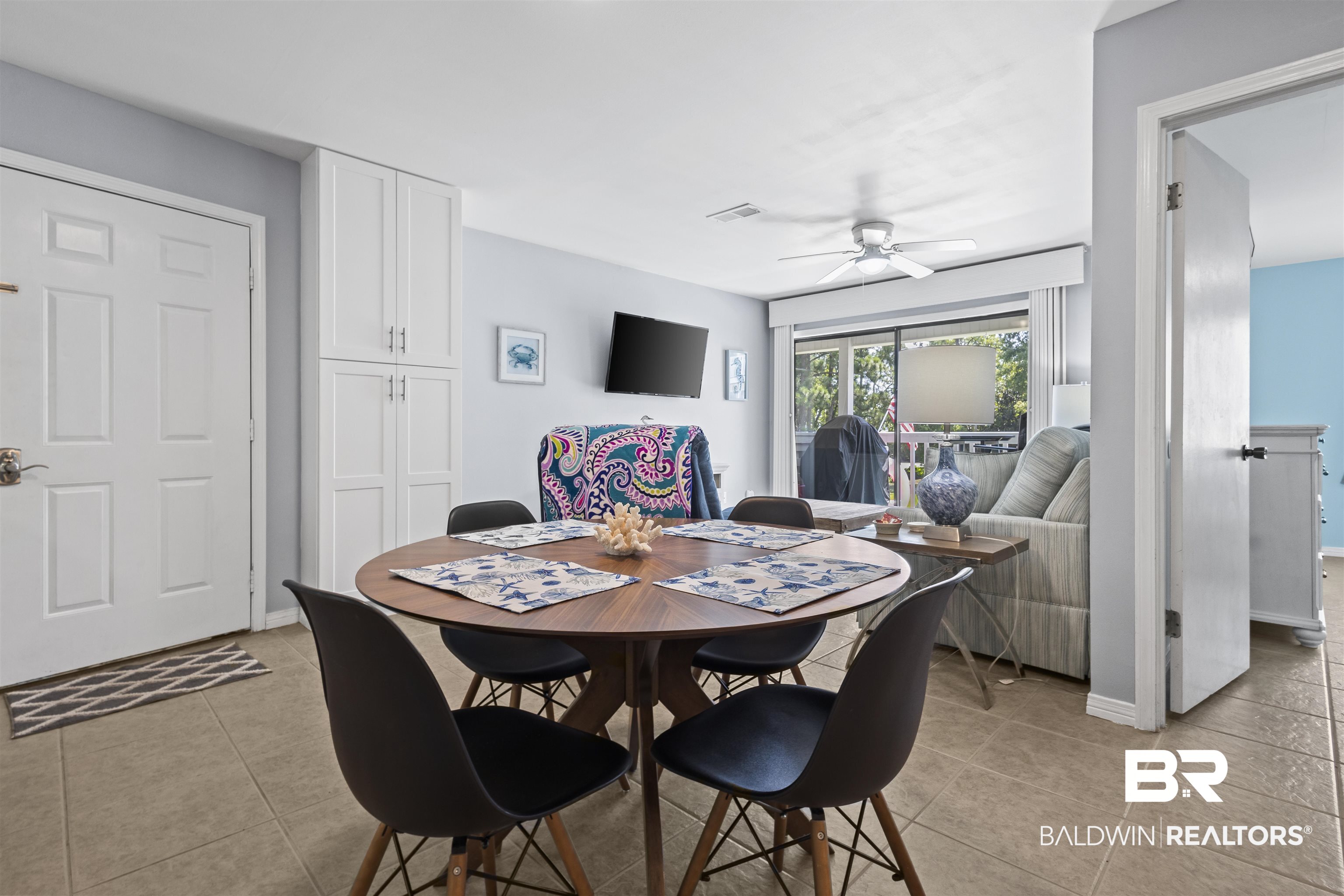 25925 Canal Road, Unit 207 Orange Beach, AL 36561 - Photo 14 of 42 Dining area with ceiling fan and light tile floors
