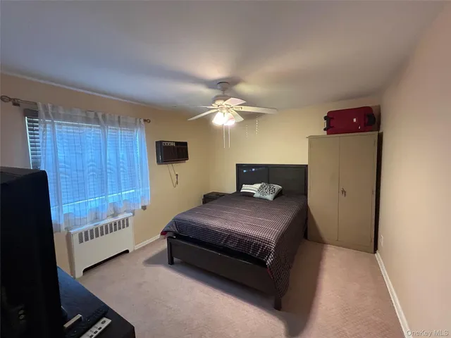 a bedroom with furniture and a flat screen tv