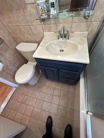 a view of an empty room with a chandelier fan