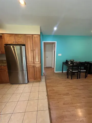 a kitchen with granite countertop a refrigerator and a stove