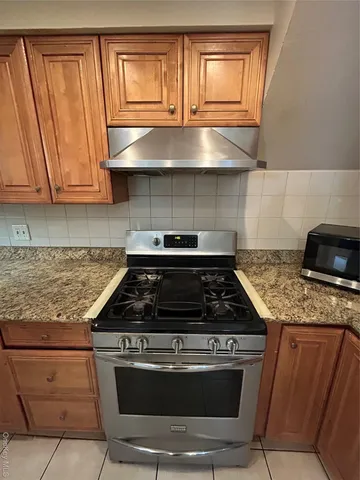 a view of a refrigerator in kitchen and wooden floor