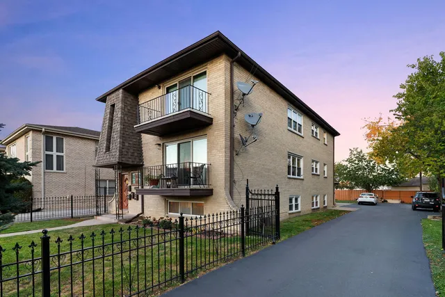 a front view of a house with garage and table