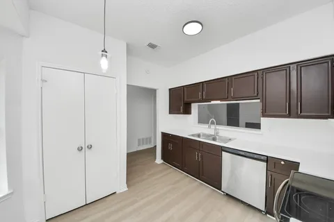 a kitchen with stainless steel appliances a refrigerator and a stove