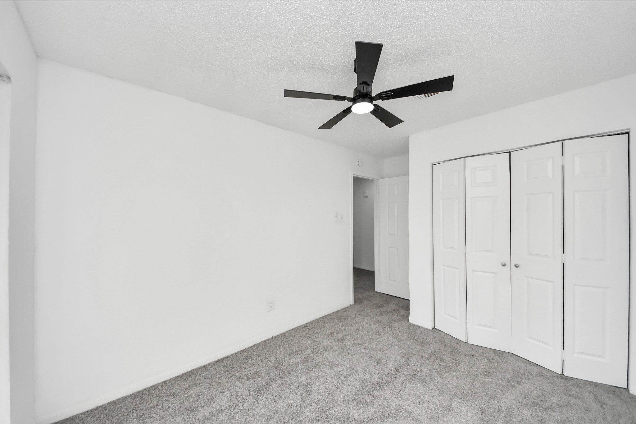 12500 Brookglade Circle, Unit 176 Houston, TX 77099 - Photo 12 of 25 a view of a hallway with a ceiling fan