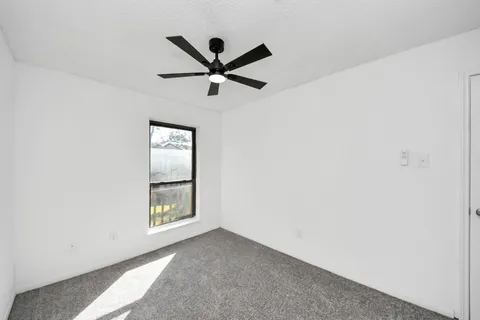 a view of a big room with closet and windows