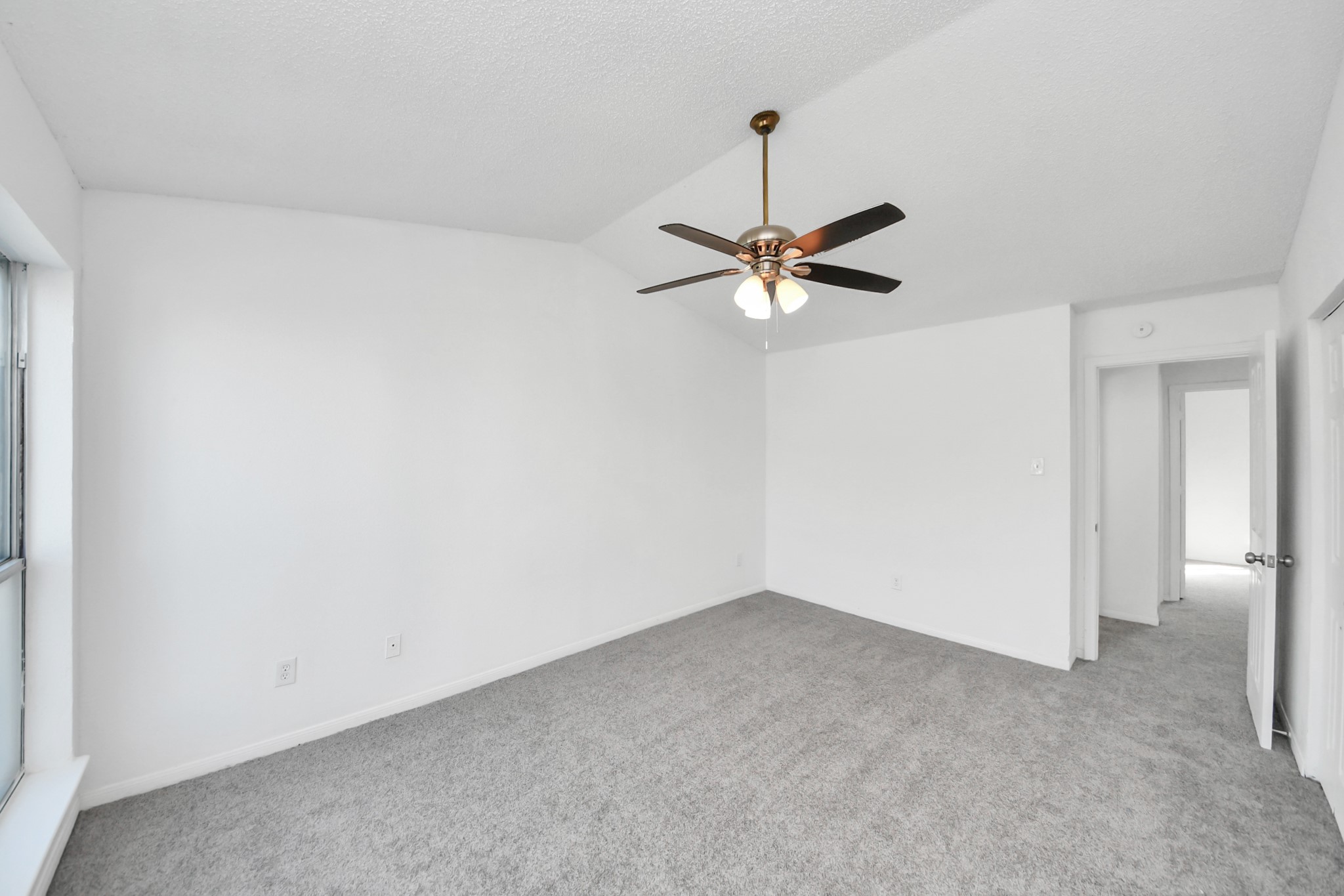 12500 Brookglade Circle, Unit 176 Houston, TX 77099 - Photo 20 of 25 an empty room with a fan and a window