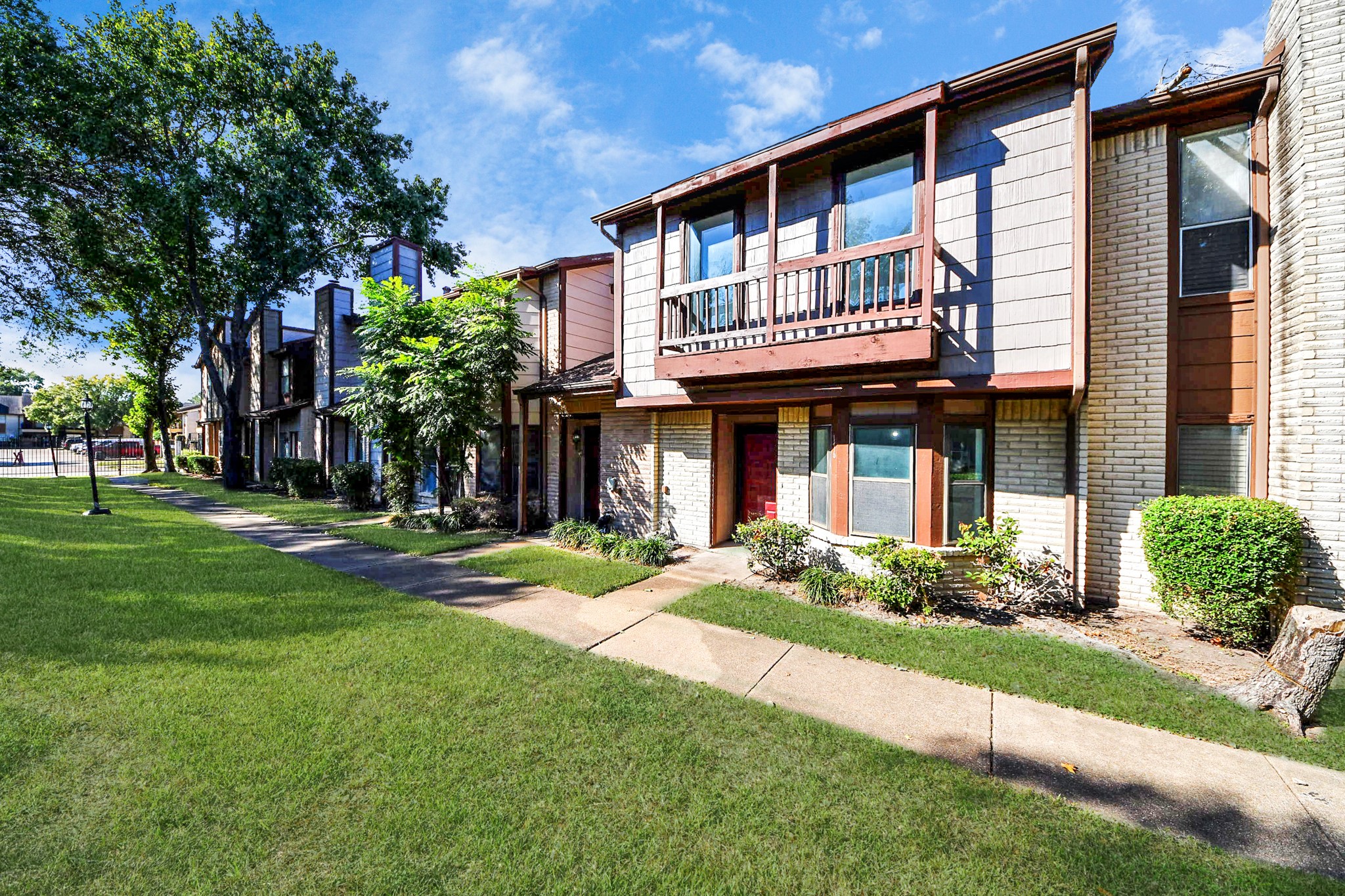12500 Brookglade Circle, Unit 176 Houston, TX 77099 - Photo 25 of 25 a front view of a house with a yard table and chairs