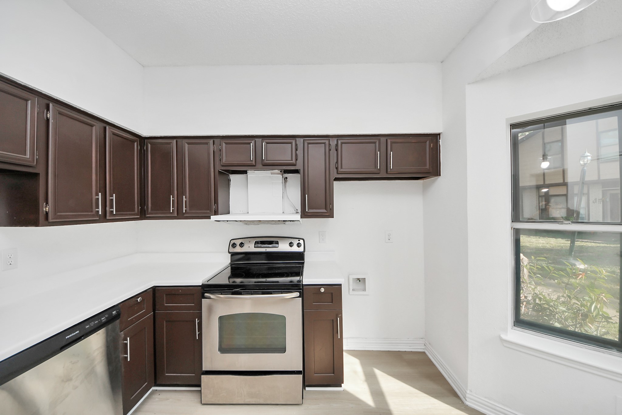 12500 Brookglade Circle, Unit 176 Houston, TX 77099 - Photo 3 of 25 a kitchen with stainless steel appliances granite countertop a stove a microwave and a sink