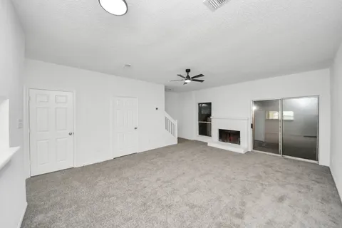a view of empty room with a fireplace