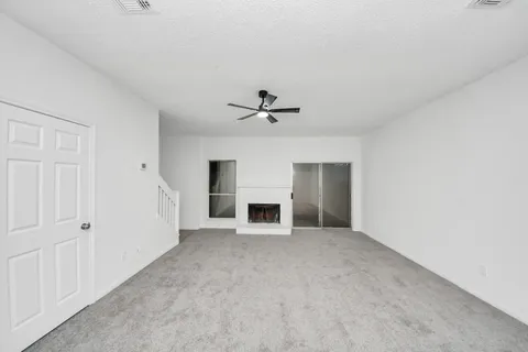 a view of a livingroom with a fireplace and window