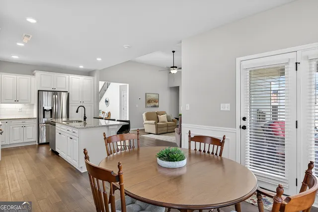 a large kitchen with lots of counter space and breakfast area
