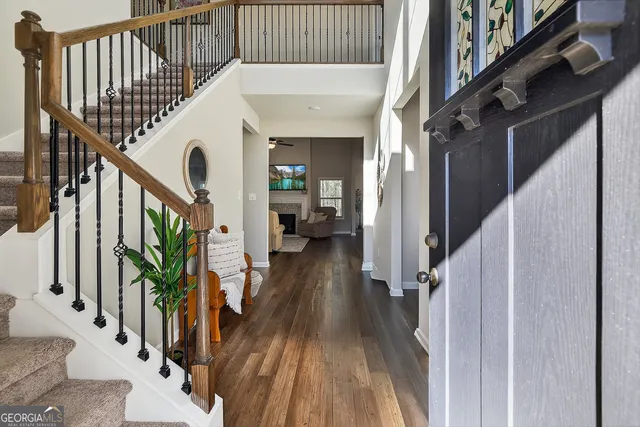 a view of entryway with wooden floor and stairs