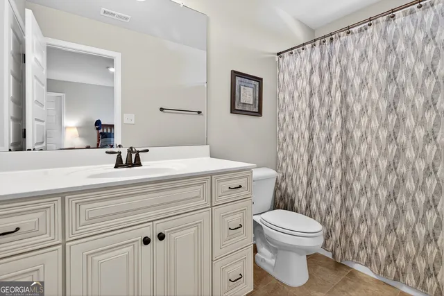 a bathroom with a toilet a sink and a mirror