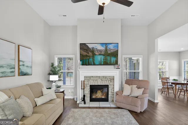 a living room with furniture a flat screen tv and a fireplace