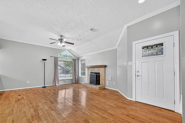 wooden floor chandelier and windows in a room