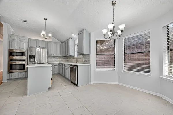 a view of a kitchen with microwave and stove