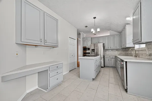 a kitchen with stainless steel appliances granite countertop a refrigerator and a sink