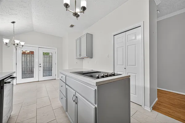 a kitchen with white cabinets and a sink