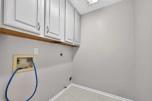 a view of a room with wooden floor and fan