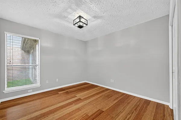 a view of a room with wooden floor
