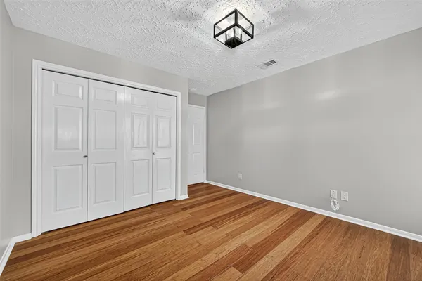 a view of room with window and hardwood floor