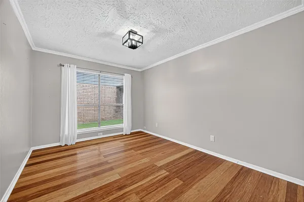 a view of a room with wooden floor