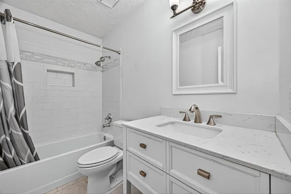 a spacious bathroom with double sink and a mirror