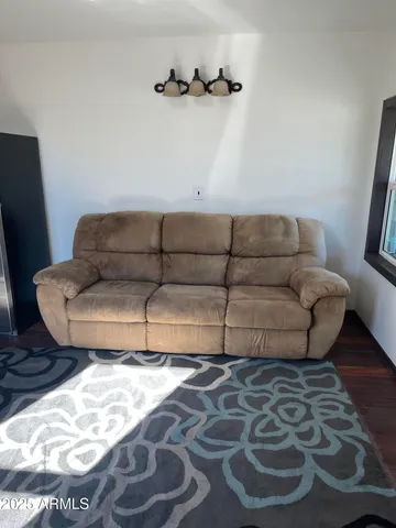 a living room with a couch and a rug