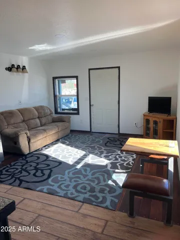 a living room with furniture rug and window