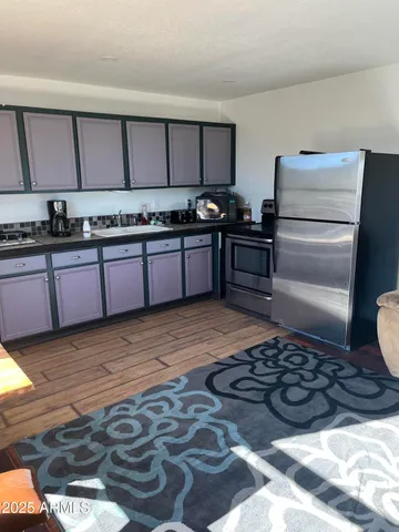 a kitchen with stainless steel appliances granite countertop a refrigerator and a stove