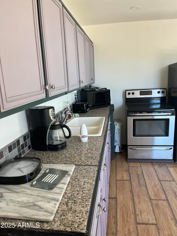a kitchen with a sink and a stove top oven